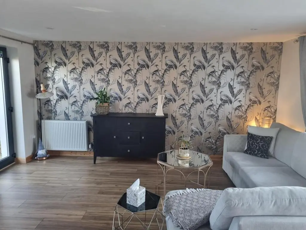 a living room with a couch and a table at Village view apartment in Auldearn