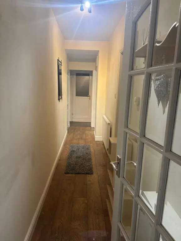 a hallway with a door leading to a room at Georges 47 king street Apartment in Inverness