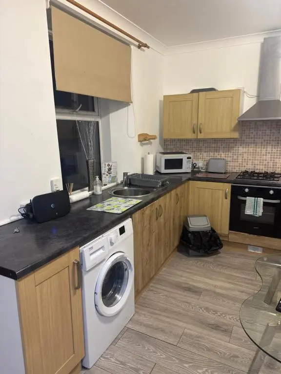a kitchen with a washing machine in a kitchen at Georges 47 king street Apartment in Inverness