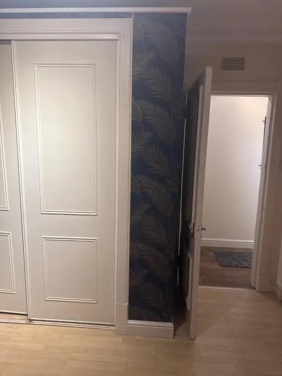 an empty room with a door and a hallway at Georges 47 king street Apartment in Inverness