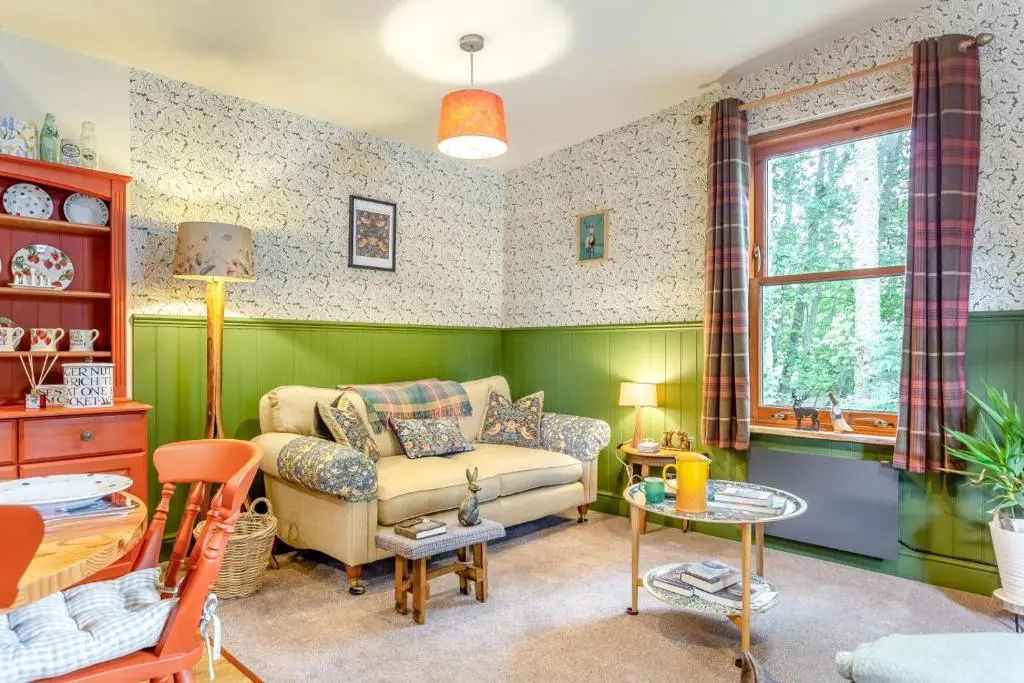 a living room with a couch and a table at 2 Bed in Invergordon oc-c33073 in Invergordon