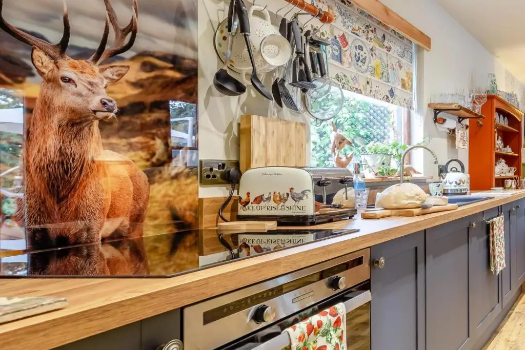 a kitchen with a picture of a deer on the counter at 2 Bed in Invergordon oc-c33073 in Invergordon