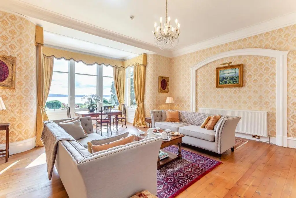 a living room with couches and a table at 8 Bed in Invergordon oc-p32711 in Invergordon