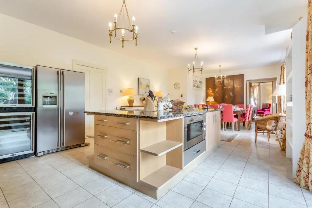 a kitchen with stainless steel appliances and a dining room at 8 Bed in Invergordon oc-p32711 in Invergordon