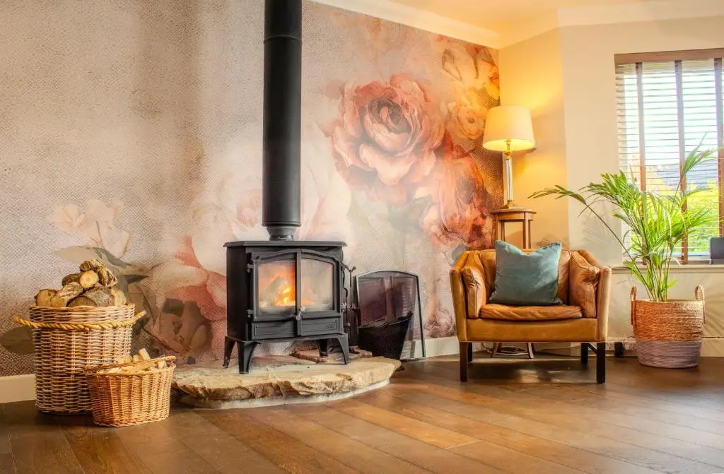 a living room with a wood stove in a room at 18 Dalfaber Park- with hot tub in Aviemore in Aviemore