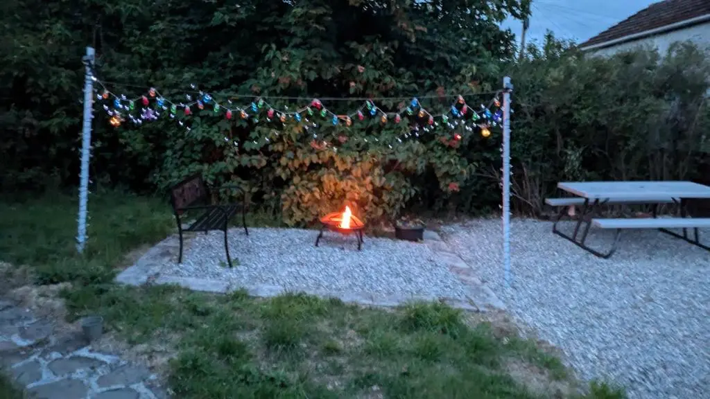 a picnic table and a fire in a yard at Ivy House in Kingussie