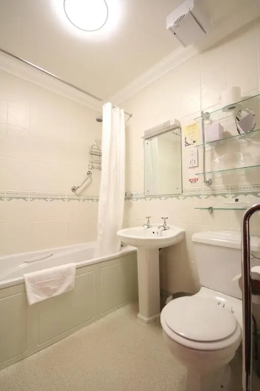 a bathroom with a toilet and a sink and a tub at Strathburn Hotel Inverurie by Compass Hospitality in Inverurie