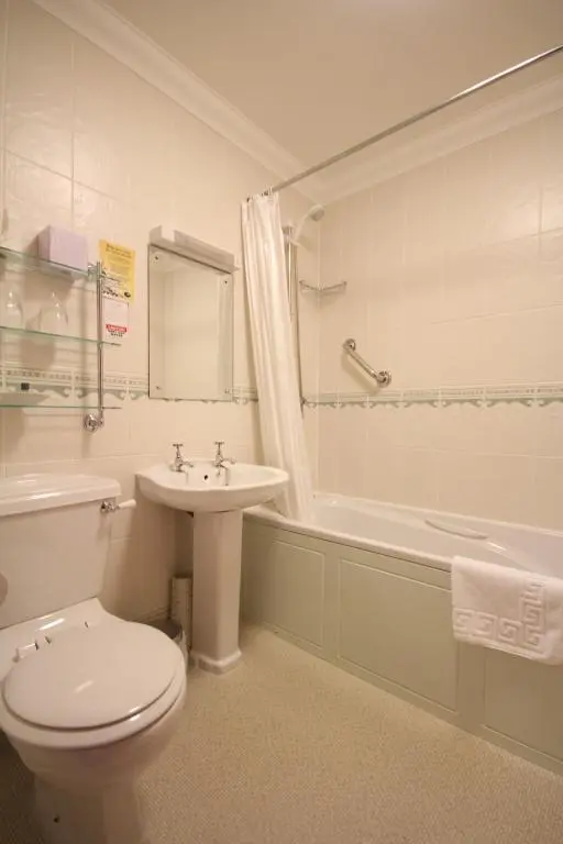a bathroom with a toilet and a sink and a tub at Strathburn Hotel Inverurie by Compass Hospitality in Inverurie