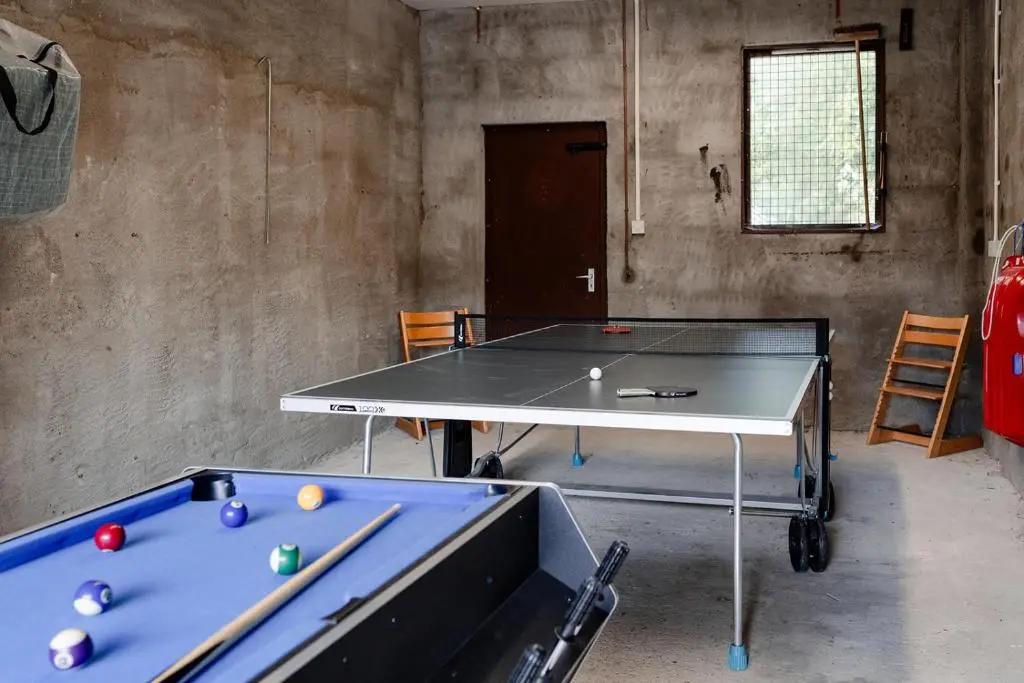 a ping pong table in a room with a ping pong ball at Kintail - Seasgair Lodges in Inverdruie
