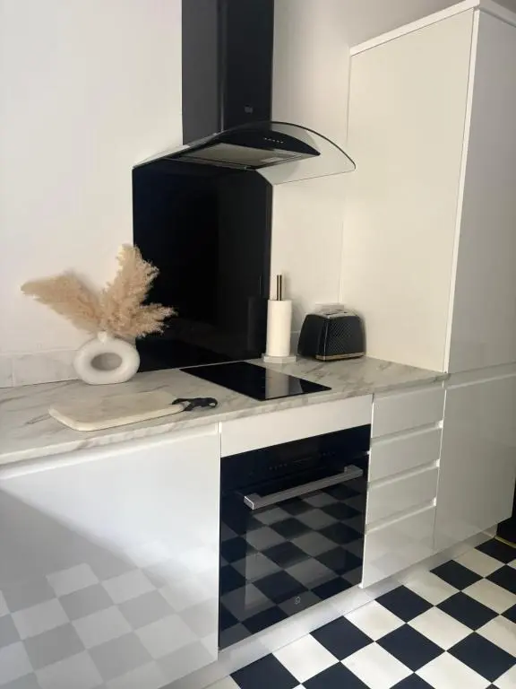 a kitchen with a black and white stove top oven at Murray Apartment in Inverness