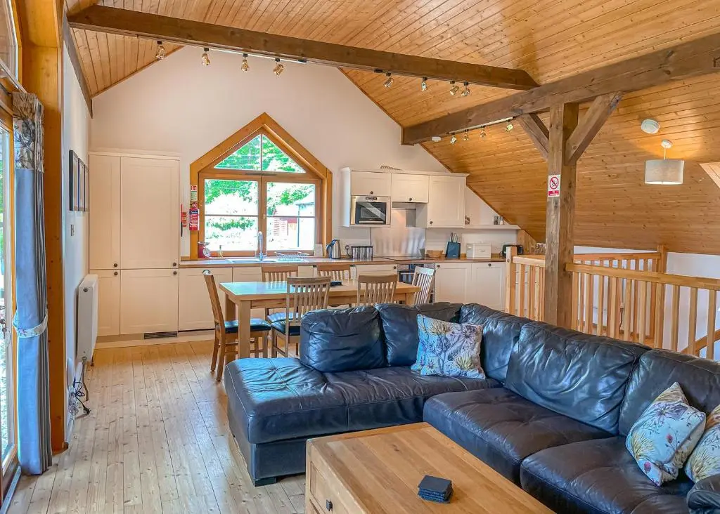 a living room with a couch and a table at Glen Clova Lodges in Angus
