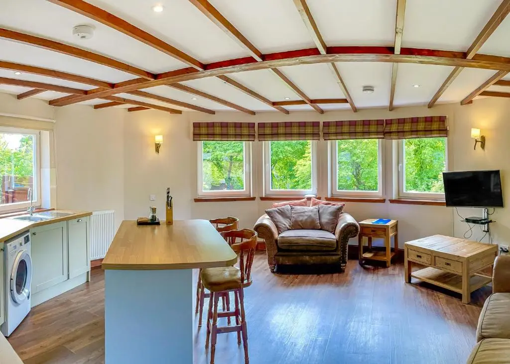 a living room with a couch and a table at Glen Clova Lodges in Angus