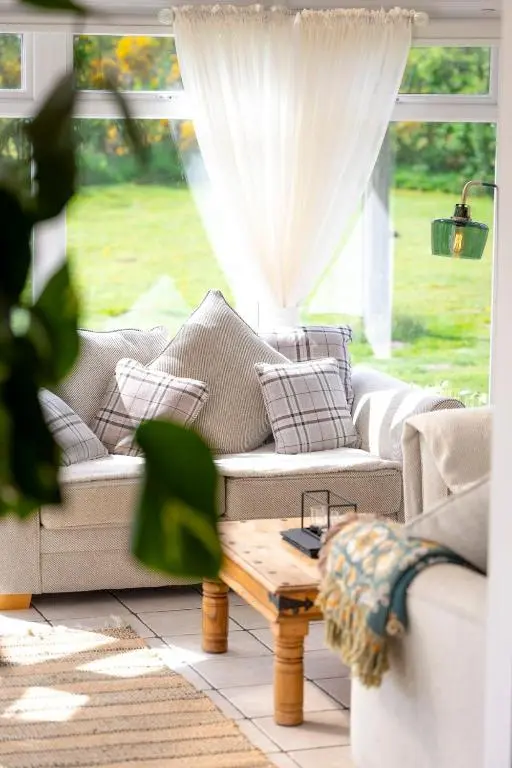 a living room with a couch and a coffee table at Wynstone Cottage, Speyside in Fochabers