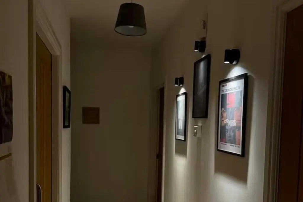 a hallway with pictures on the walls of a building at 1 Bed Flat - Sleeps 2 - Parking - Wifi in Nairn