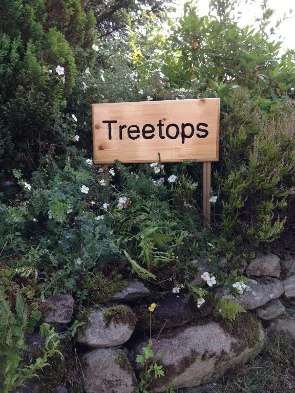 a sign with the word tigers written on it at Treetops Bungalow Loch Ness in Drumnadrochit