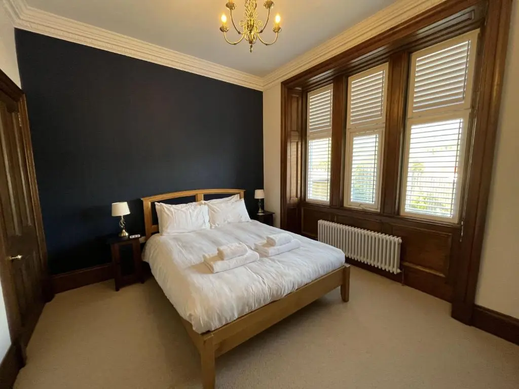 a bedroom with a bed with two towels on it at Bank House apartment in Fort Augustus