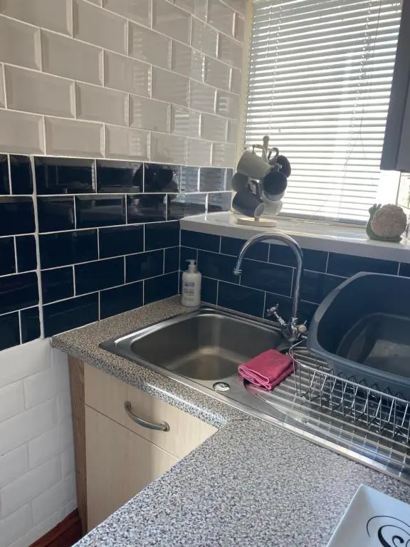 a kitchen counter with a sink and a sink at Georges holiday apt the blue suite in Inverness