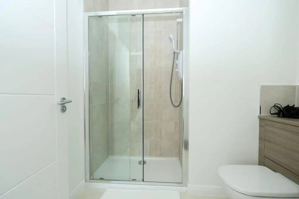 a shower with a glass door in a bathroom at Inverness Haven: Bright 2B/2B with Scenic Views in Inverness