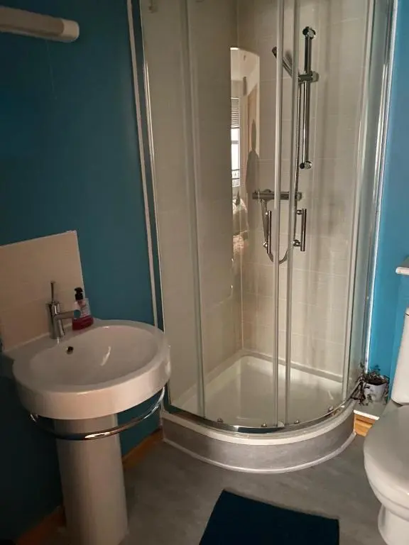 a bathroom with a shower and a sink at Georges 1Faraline court Apartment in Inverness