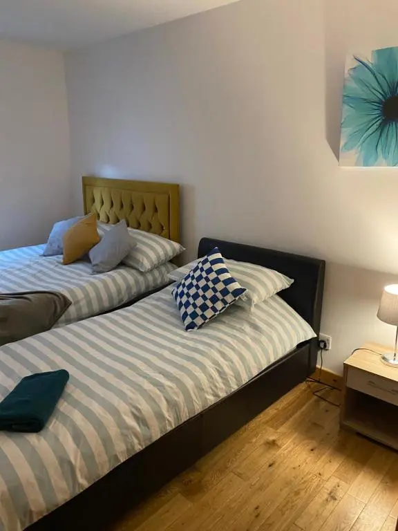 two beds sitting next to each other in a bedroom at Faraline in Inverness