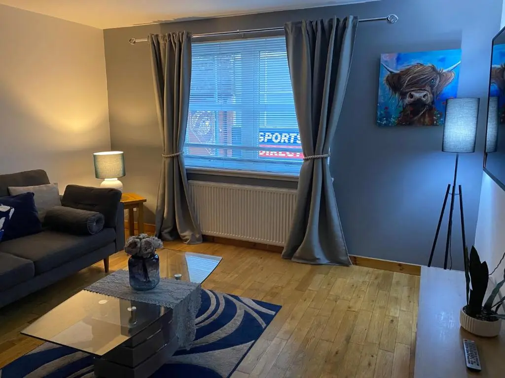 a living room with a couch and a window at Faraline in Inverness
