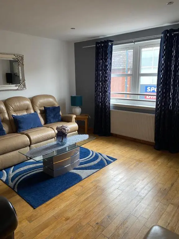 a living room with a couch and a table at Faraline in Inverness