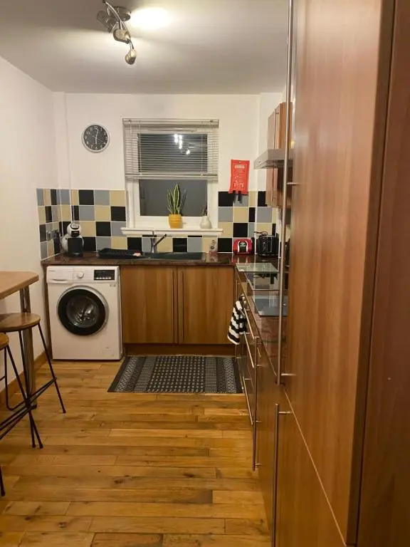 a kitchen with a washer and dryer in a room at Faraline in Inverness