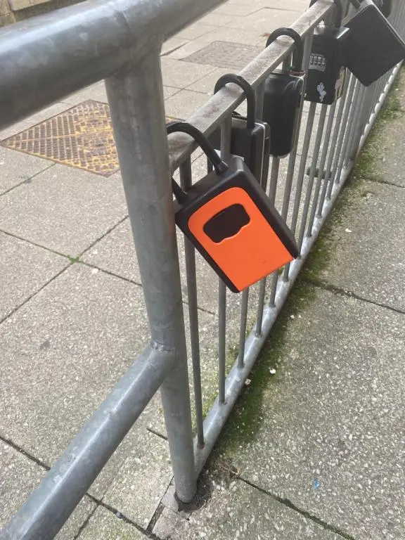 an orange object is attached to a metal fence at Faraline in Inverness