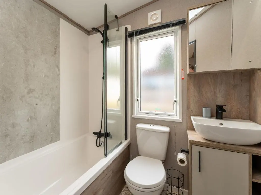a bathroom with a toilet and a sink at Chalet Lodge 15 by Interhome in Boat of Garten
