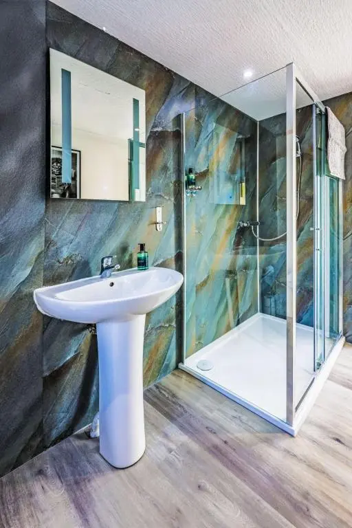 a bathroom with a sink and a shower at Holiday Home Gordonstoun Cottage by Interhome in Elgin