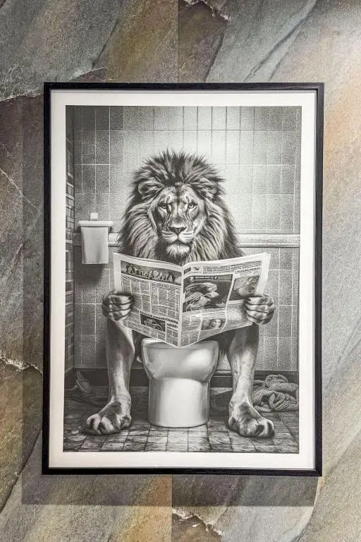 a picture of a lion reading a newspaper in a bathroom at Holiday Home Gordonstoun Cottage by Interhome in Elgin