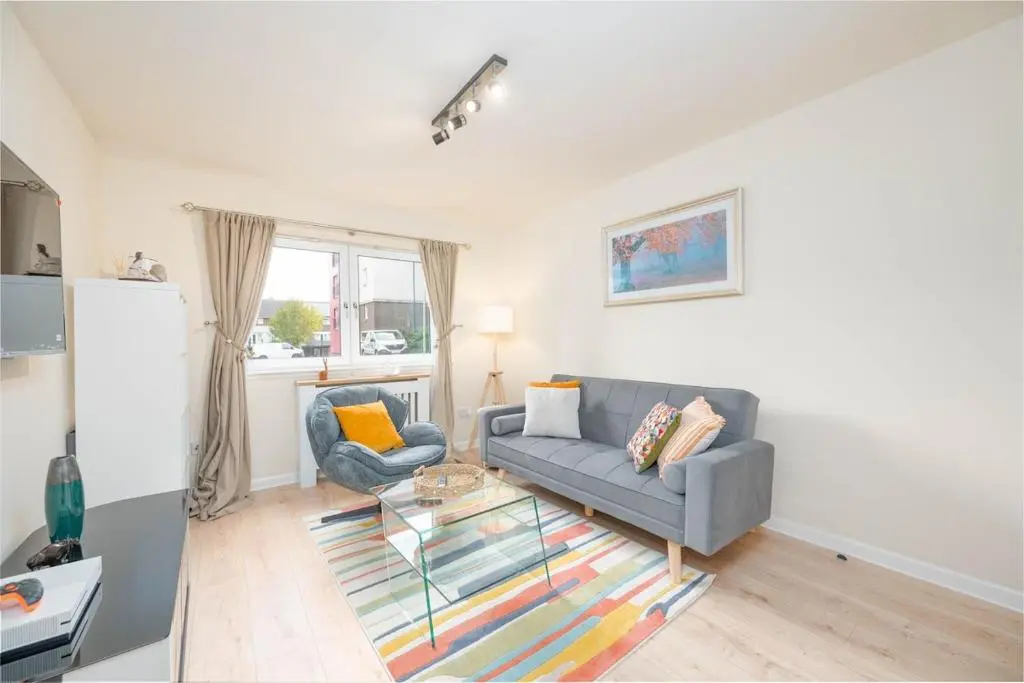 a living room with a couch and a table at Aberdeen 2BR Flat Near Airport & City Centre in Aberdeen