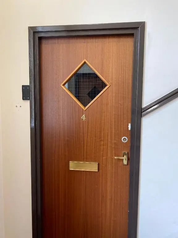 a wooden door with a sign on it at Lombard in Inverness