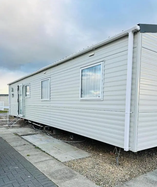 a white trailer with two windows on the side of it at Aurora Sky in Lossiemouth