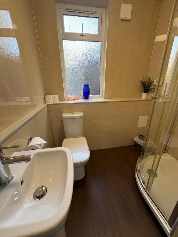 a bathroom with a sink and a toilet and a window at Cannich at RHA in Dalneigh