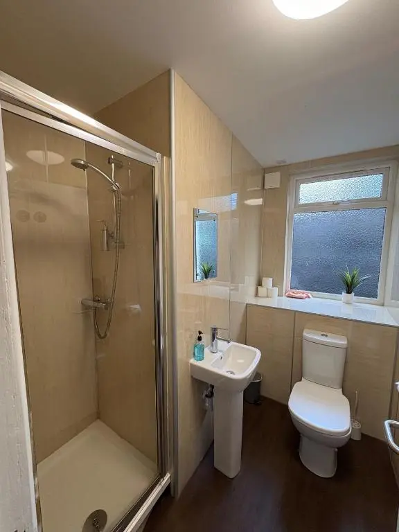 a bathroom with a shower and a toilet and a sink at Cannich at RHA in Dalneigh