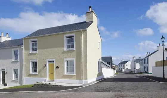 a house with a yellow door on a street at Picturesque Tornagrain Apartment 2bed Free Parking WiFi - Near Inverness Airport