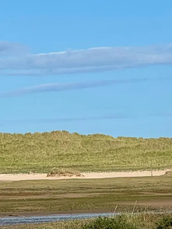 a field with a dirt road in the distance at Sutherland C14 in Lossiemouth