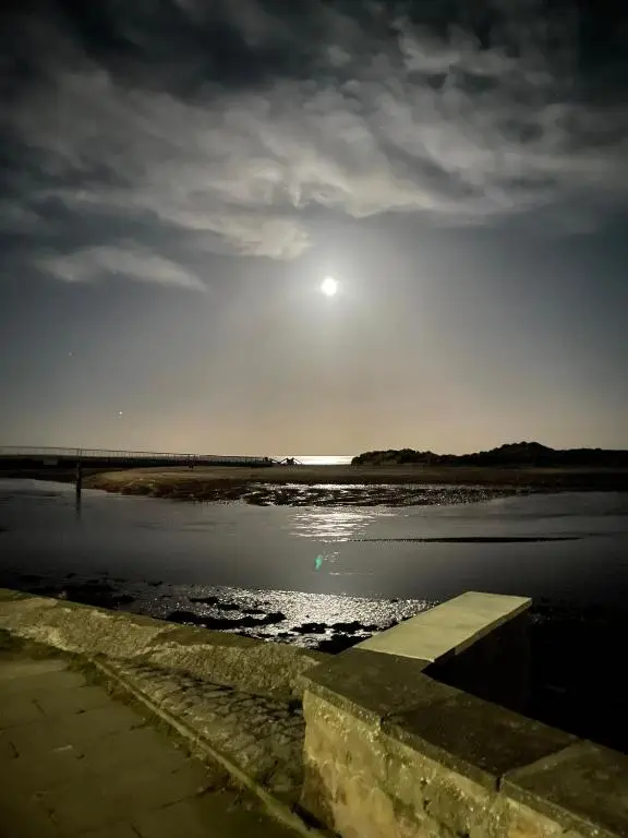 a view of the sun rising over the water at Sutherland C14 in Lossiemouth