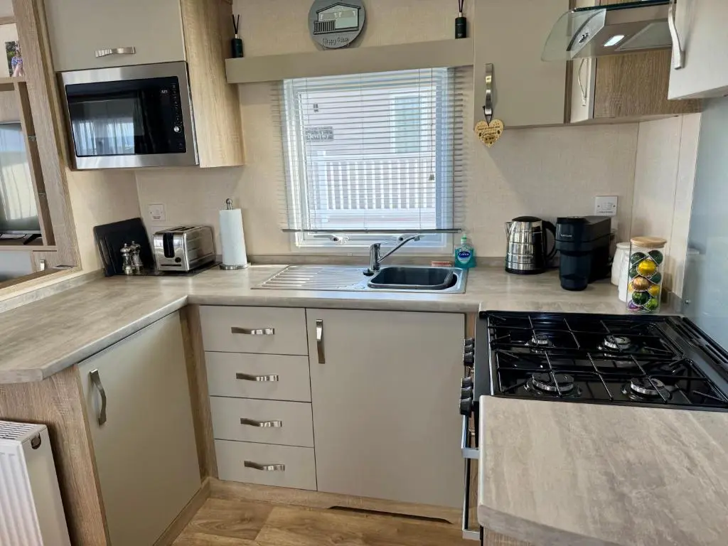 a small kitchen with a sink and a stove at Sutherland C14 in Lossiemouth