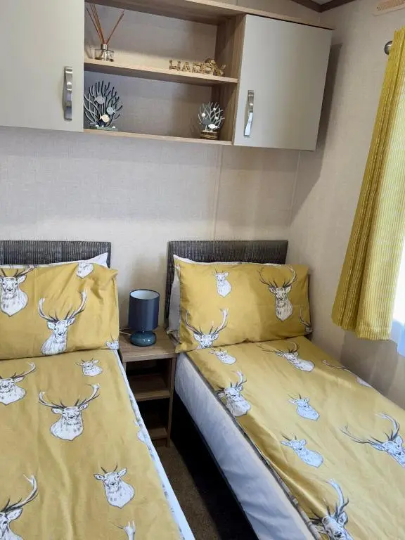 two beds sitting next to each other in a room at Sutherland C14 in Lossiemouth