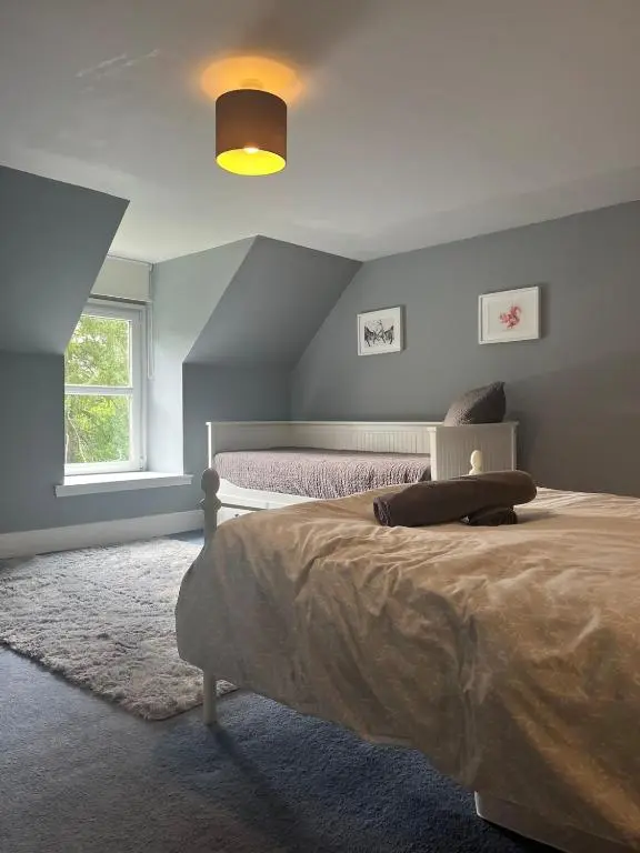 a bedroom with a bed and a window at Charming cottage close to the Cairngorms in Ballindalloch