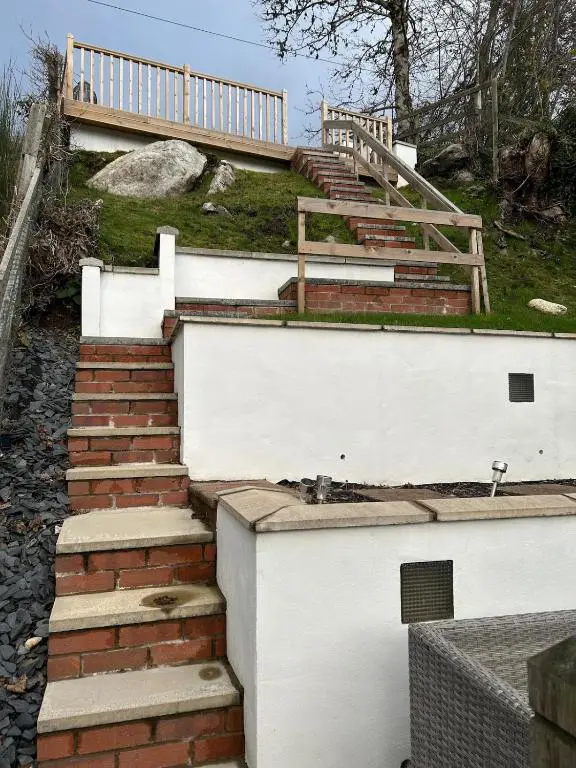 a set of stairs leading up to a white building at Glenburn Cottage in Kirkmichael