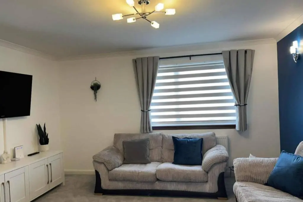 a living room with a couch and a window at The Burghead Hideaway in Burghead