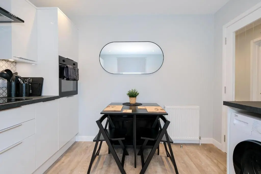 a small table in a kitchen with a mirror at High Street Retreat in Inverurie