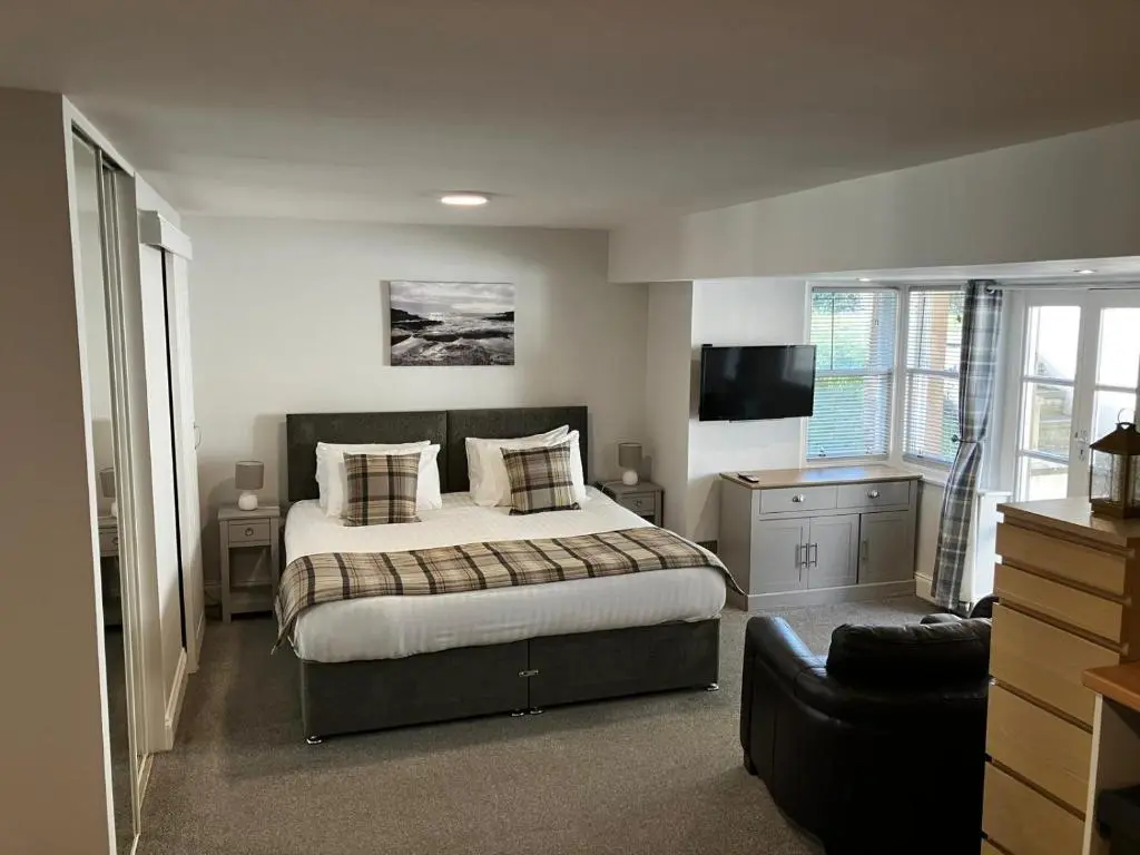 a bedroom with a bed and a television in it at The Bunker Self Catering in Nairn