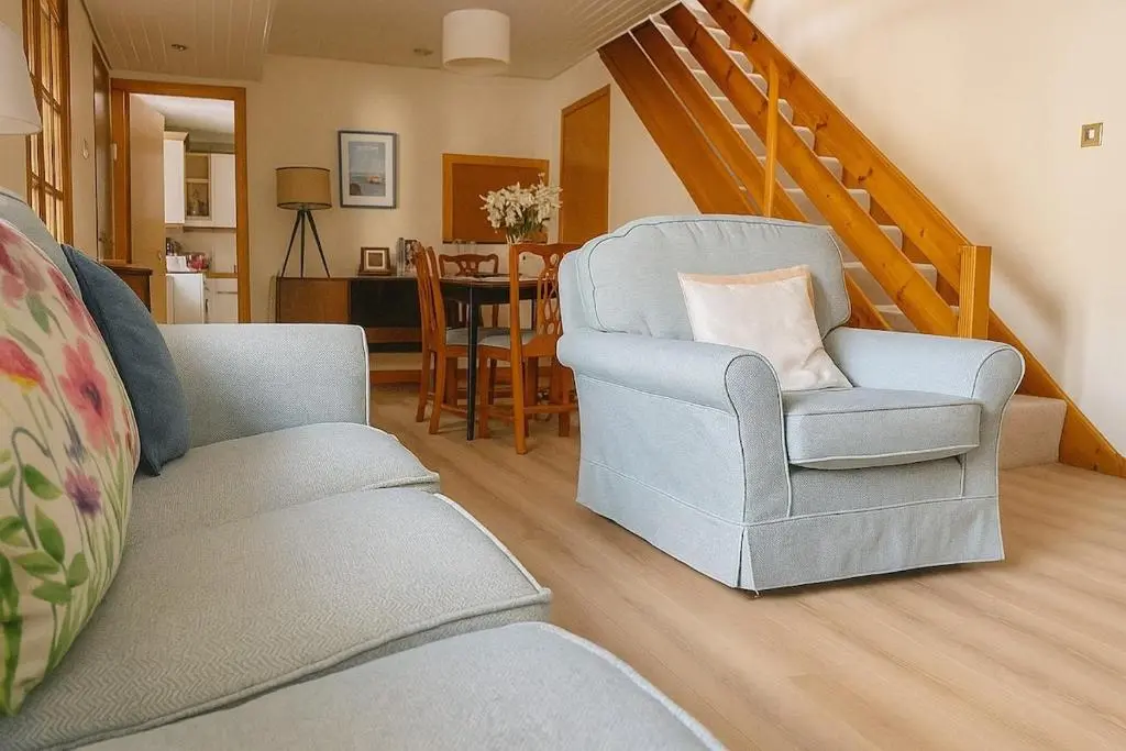 a living room with a couch and a chair at Beachy Days and Family Stays in Nairn