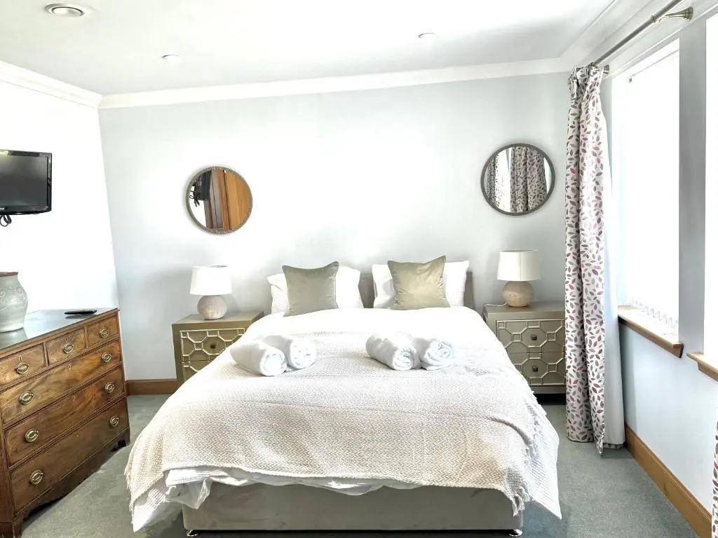 a bedroom with a bed with two towels on it at Golf View Spacious Bungalow 2 Bathrooms, Free Parking WiFi in Elgin