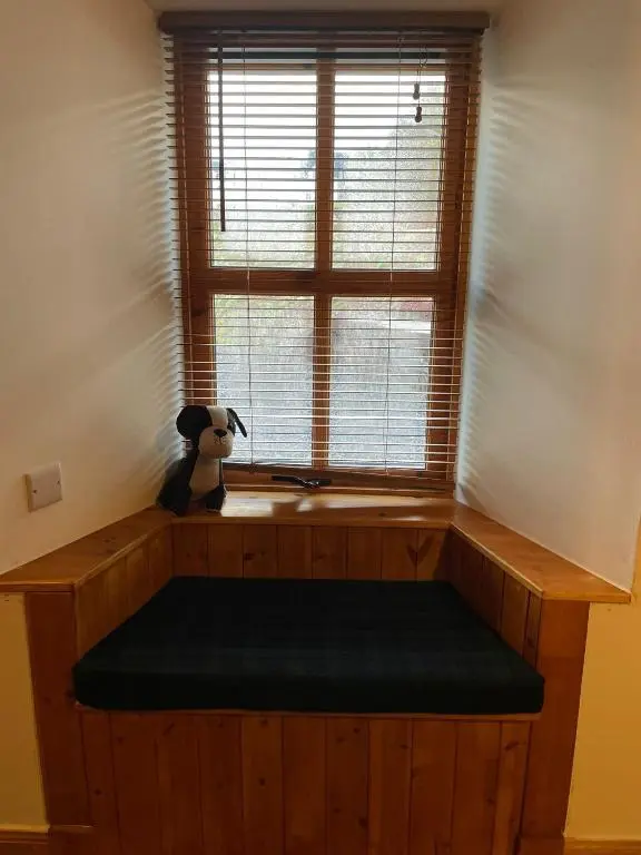 a window with a bench in front of it at Culrain Cottage in Fort Augustus