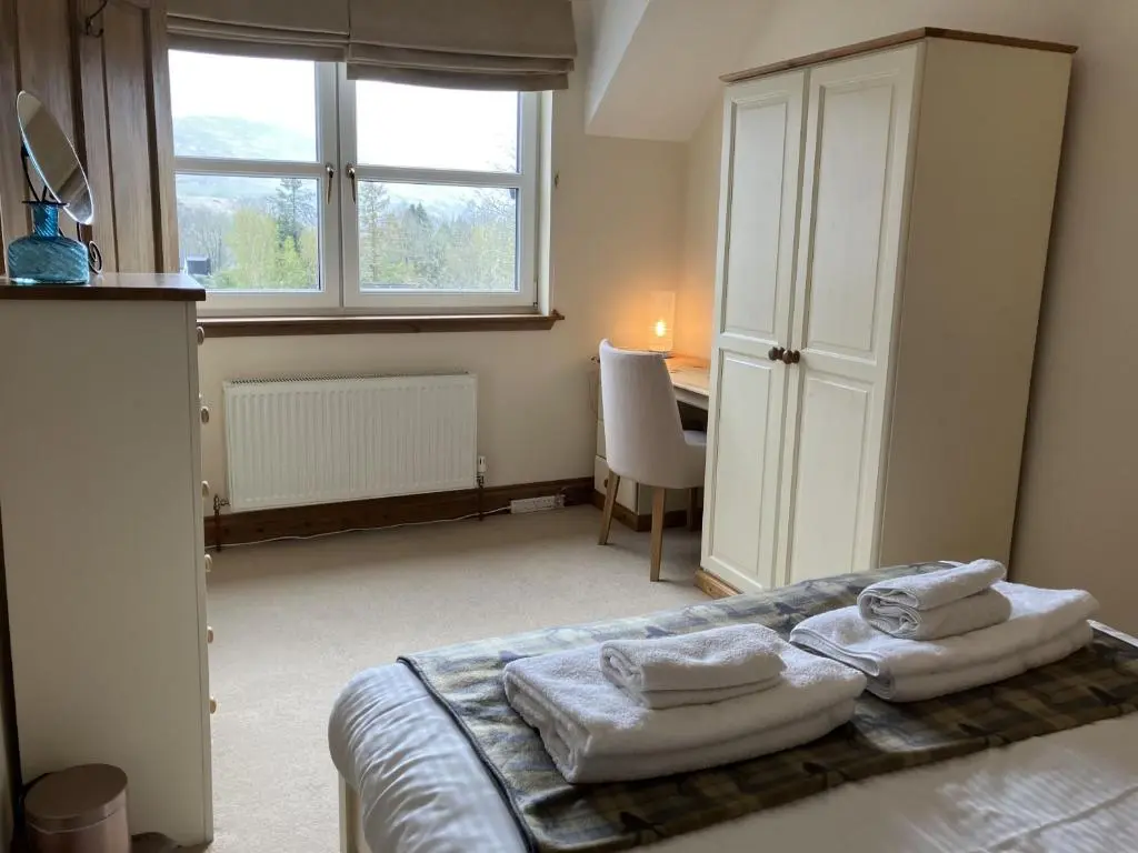a bedroom with a bed with towels on it at Oiseval in Fort Augustus
